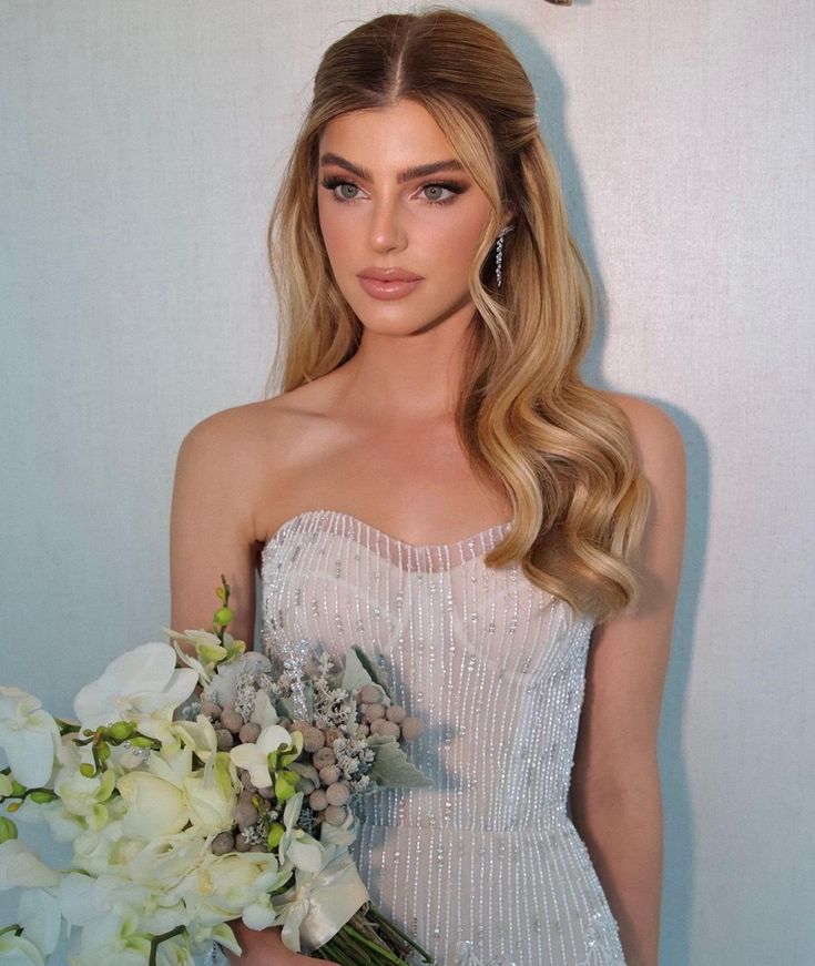 a beautiful woman holding a bouquet of flowers