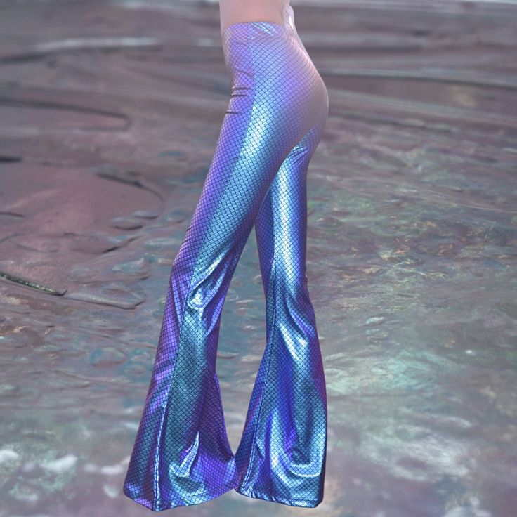 With its charming stance, Crystal Fantasy invites you to a festival in a magical world as a star. Details & Care  Elastic glitter fabric Push-up model flare pants XS - S / M- L /XL - 2XL sizes available MODEL IS WEARING XS - S and she is 52 kg / 116pounds. JOIN THE UNICORNY COMMUNITY AND BECOME UNIQUE Summer Party Mermaid Bottoms, High Waist Bottoms For Club And Party Season, High Waist Bottoms For Club Party, High Waist Bottoms For Party Season, Stretch Fishtail Bottoms For Night Out, Fitted Full-length Pants For Festival, High Waist Rave Bottoms For Club, Fitted Purple Bottoms For Club, Fitted Purple Bottoms For Party Season