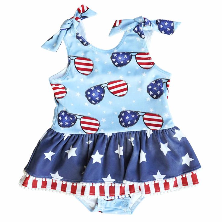 Add a splash of patriotism to your little girl's poolside style with this one piece swimsuit! The playful design features an adorable skirt lined with white pom poms with a classic red, white and blue pattern, with festive flag sunglasses to add a fresh twist to this patriotic look that you know and love. Made for comfort and durability, this high-quality UPF 50+ fabric ensures your little one stays protected from the sun during every 4th of July celebration! Details: 80% Nylon, 20% Spandex UPF Personalized Newborn Outfit, White And Blue Pattern, Poolside Style, Personalized Swaddle, Newborn Accessories, Personalized Sweater, Poolside Fashion, Sibling Shirts, Bamboo Pajamas