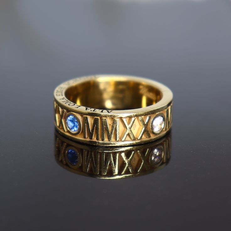 "Roman Numeral Class Ring , Graduation Ring , High School Class Ring , Graduation gift. Fully customizable roman numeral ring in memory of your graduation. Specs: * Solid, heavy body ✔️ * Unisex use , for men and for women. * Ring Face width: ± 7 mm , 6 mm , 5 mm * Ring weight : ± 10 gr , 8 gr , 7 gr * Ring material : 925 sterling silver (stamped) Personalization : * Your graduation year on ring face with roman numerals. * Top side : School name. * Bottom side : Surname * Inside engraving Name a Luxury Engraved Anniversary Ring, Gold Sapphire Heirloom Ring For Anniversary, Gold Sterling Silver Sapphire Promise Ring, Gold Sapphire Ring In Sterling Silver For Promise, Heirloom Style Sapphire Ring With Open Design, Heirloom Sapphire Open Ring Gift, Symbolic Anniversary Ring Jewelry, Luxury Hallmarked Birthstone Ring For Anniversary, Handmade 14k Gold Birthstone Ring For Anniversary