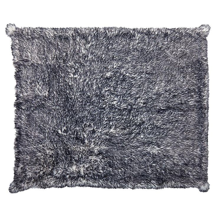 a black and white shaggy rug on a white background with no one in the photo