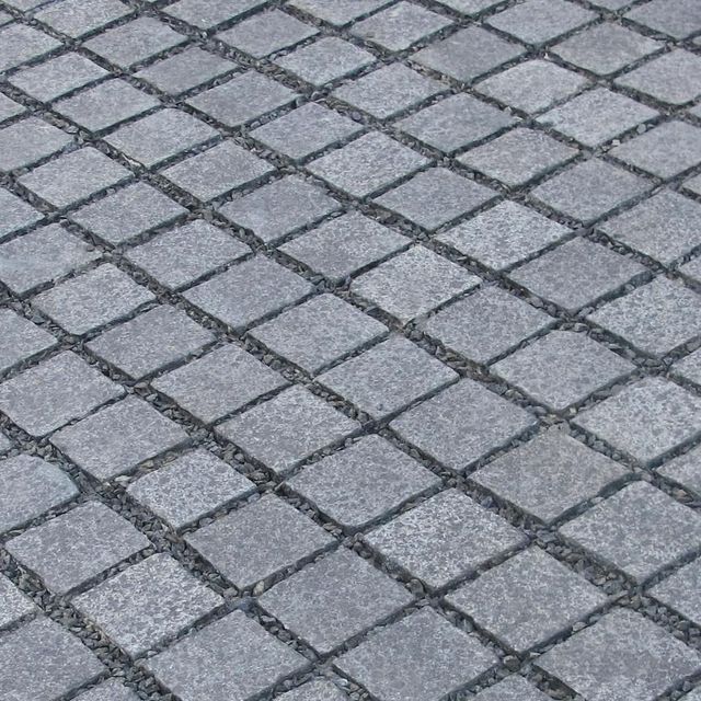 a close up view of a gray brick sidewalk