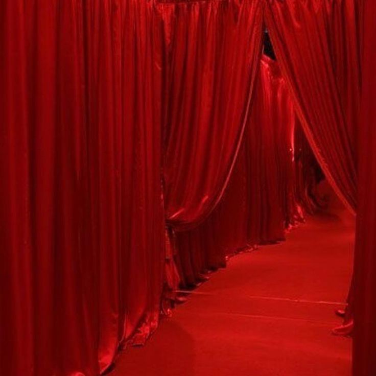 the red curtains are lined up on the floor