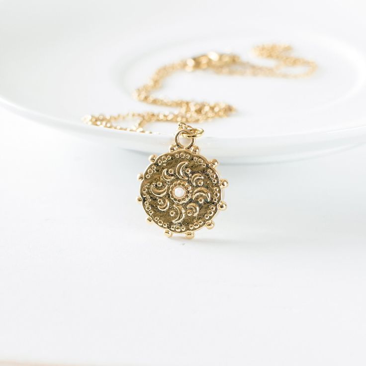 "Lovely gold plated moon phases necklace. This celestial inspired necklace is made from a gold plated brass pendant with a tiny opal stone and a gold plated stainless steel chain. Measurements & Details: * The moon pendant is about 0.8\" (2cm), the chain is available in various lengths 16\"- 30\" (41-76cm). * This celestial necklace comes in a gift box - perfect for gift giving and safekeeping. * Buying this lunar necklace as a gift? Add a handwritten card with a message of your choice. ➳ Want t Celestial Brass Necklace With Adjustable Chain, Celestial Style Pearl Pendant Necklaces, Bohemian Yellow Gold Necklace With Moon Charm, Celestial Brass Necklace With Moon Charm, Brass Moon Charm Necklace, Brass Moon Charm Round Necklace, Gold Moon-shaped Bohemian Jewelry, Round Brass Necklace With Moon Charm, Gold-tone Brass Charm Necklace With Round Pendant