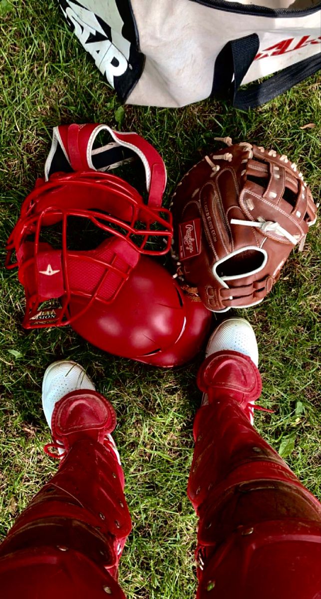 a baseball catchers mitt and glove laying on the ground next to each other