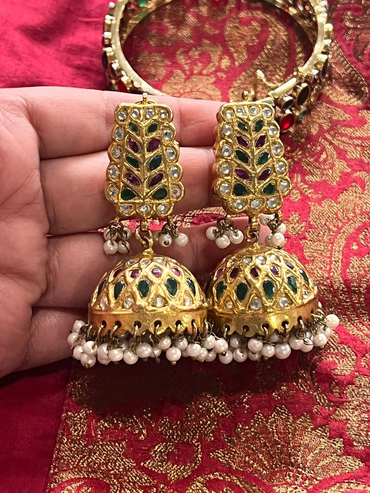 Beautiful traditional Jhumkas with Polki, pink and green jade stones. These are high quality beautiful Jhumkas,perfect for any festivities and occasion.  The earring are on the heavier side weigh around 59 grams.   There are huge cluster of faux pearls hanging from each jhmukis. Temple Jewelry Style Jhumkas With Latkans For Festivals, Temple Jewelry Jhumkas With Latkans For Festivals, Traditional Chandbali Jhumkas With Latkans, Traditional Intricate Design Jhumkas For Festivals, Traditional Jhumkas With Intricate Design For Festivals, Traditional Intricate Jhumkas For Festivals, Bollywood Style Jhumkas With Intricate Design For Ceremonial Occasions, Bollywood Style Ceremonial Jhumkas With Intricate Design, Ceremonial Festive Jhumkas With Intricate Design