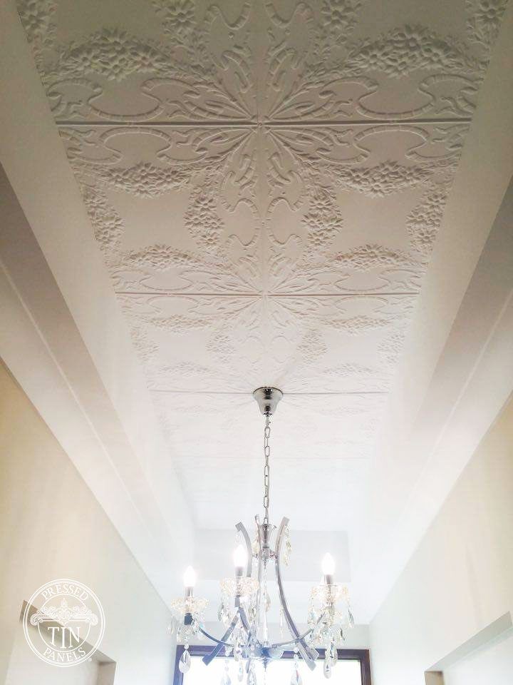 a chandelier hanging from the ceiling in a room with white walls and ceilings