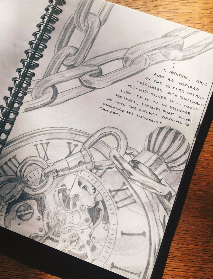 a drawing of a watch with chains attached to the front and side of it, on top of a spiral notebook