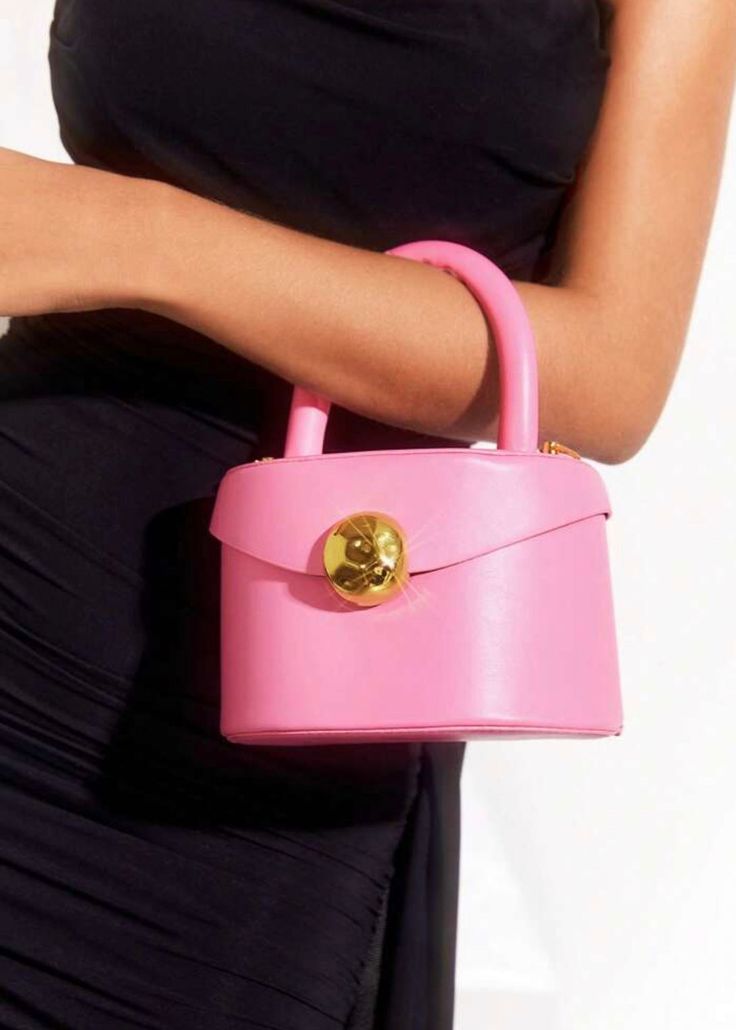 Introducing our Eco Leather Top Handle Mini Bag, featuring a detachable shoulder strap and stylish rivet detail. Made from eco-friendly materials, this bag is both fashionable and sustainable. Its baby pink color adds a touch of femininity to any outfit. Upgrade your accessories with this must-have bag. Material: Polyurethane Pink Rectangular Bag With Metal Hardware, Pink Travel Bag With Metal Hardware, Pink Top Handle Shoulder Bag With Metal Hardware, Pink Satchel Box Bag With Top Carry Handle, Trendy Bags With Removable Pouch And Round Handle, Pink Box Bag With Adjustable Strap For Shopping, Everyday Pink Box Bag With Top Carry Handle, Pink Shoulder Bag With Metal Hardware For Shopping, Pink Crossbody Satchel With Detachable Handle