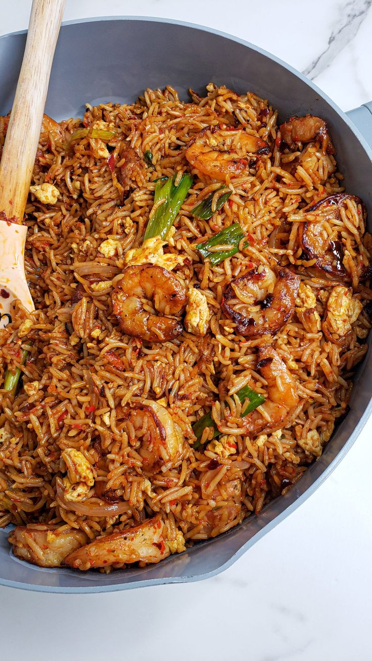 a pan filled with fried rice and shrimp