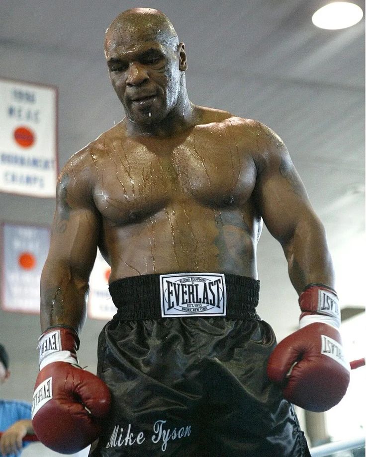 a close up of a person wearing boxing gloves