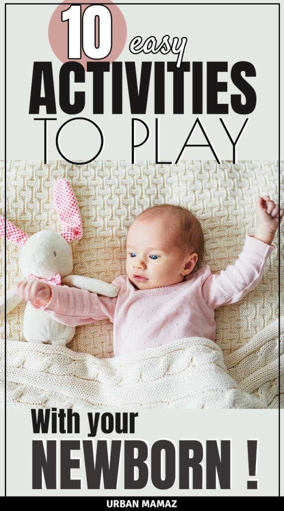 a baby laying on top of a bed with a stuffed animal in it's arms