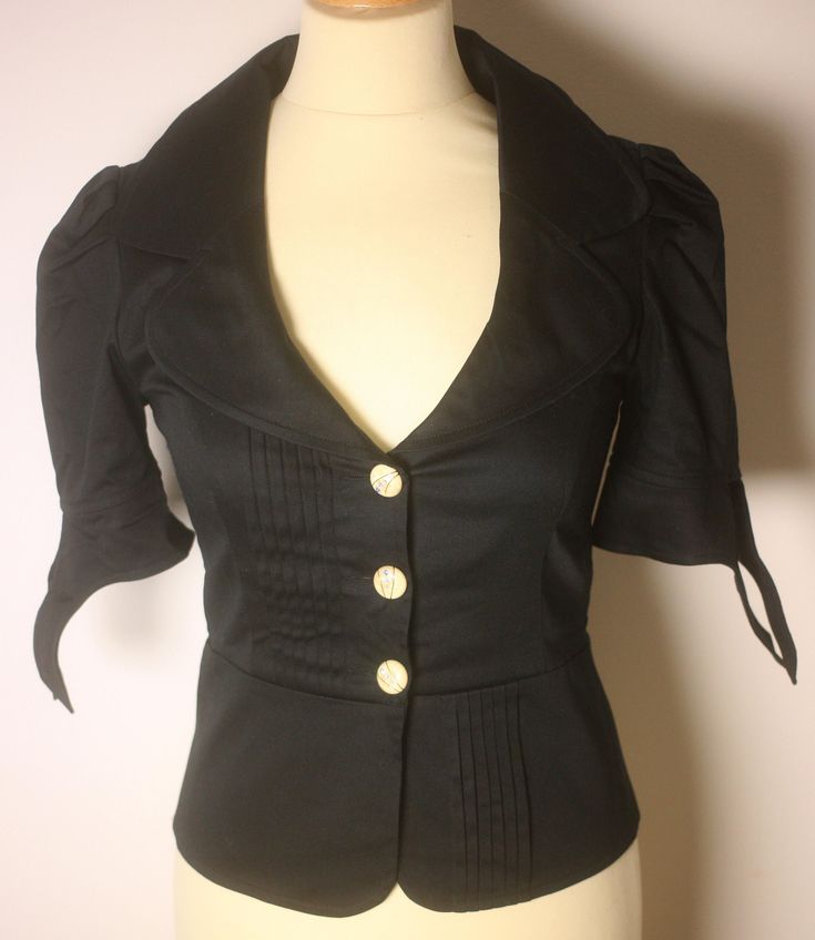 Jovovich Hawk ladies black cropped summer jacket with tied sleeves-Size 2-UK 8-EU 36-US 4-circa 1990s (Weight: 300g) Free postage The jacket is a listed Size 2 but the mannequin in the pictures is a standard UK 8 size and the jacket is fitted and tight when all of the buttons are fastened The jacket has short sleeves with tie ends, a pleated front and 3 buttons for fastening The jacket is used but overall is in excellent condition, and is made of 95% Cotton and 5% Elastane with the following approximate measurements: Overall length (edge to edge): 50cm (from behind); Armpit to armpit (across front): 45cm; Sleeve length (shoulder seam to cuff edge): 23cm FREE POSTAGE WORLDWIDE Fitted Cropped Blazer With Button Closure, Fitted Long Sleeve Cropped Jacket For Summer, Fitted Cropped Jacket For Summer, Fitted Black Summer Blazer, Retro Fitted Cropped Outerwear, Fitted Retro Cropped Outerwear, Fitted Cropped Blazer For Parties, Elegant Fitted Cropped Summer Jacket, Elegant Fitted Cropped Jacket For Summer