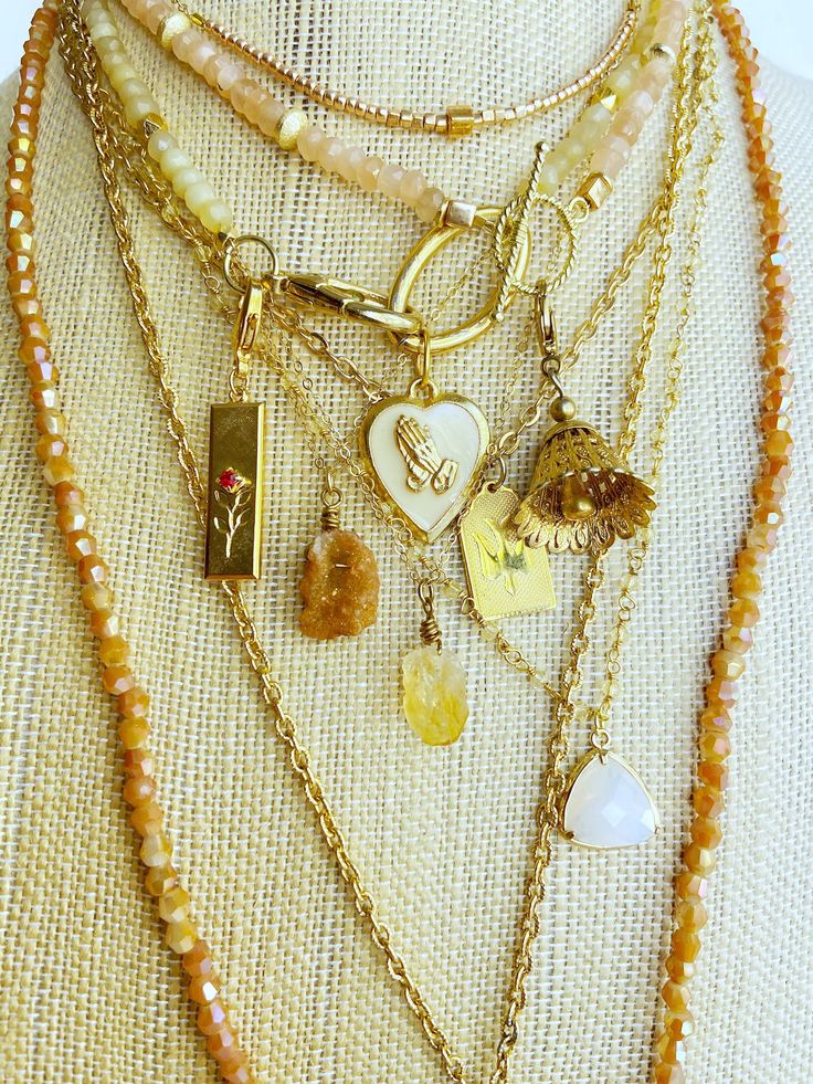 Yellow and orange gemstone neck mess built with semiprecious gemstone necklaces, vintage chains, and raw gemstone and vintage pendants.  Choose your components at checkout from a variety of gemstone and vintage components to build your own neck mess! Replicate this one or mix and match to suit yourself.  Find my other gemstone necklaces here: https://www.etsy.com/shop/LittleRabbitJewelry?ref=seller-platform-mcnav§ion_id=38334489 **As with all handmade jewelry, it is not recommended to shower or use perfume or lotions while wearing your handmade pieces. Baby your jewels and they will give you lots of love 💕 Any questions please ask!! Necklaces Vintage, Stone Necklaces, Necklaces Gold, Long Beaded Necklace, Charm Necklaces, Modern Necklaces, Hippie Jewelry, Raw Gemstones, Pink Quartz