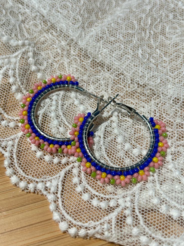 Hand beaded hoop earrings.  Hinge closure. Hoop measures approximately 1" wide. Beaded Hoop Festival Jewelry, Beaded Hoop Jewelry For Festivals, Beaded Small Hoop Earrings In Metal, Small Hoop Beaded Metal Earrings, Nickel Free Small Hoop Beaded Earrings In Trendy Style, Beaded Metal Hoop Earrings, Beaded Metal Small Hoop Earrings, Small Beaded Metal Hoop Earrings, Small Beaded Hoop Earrings In Metal