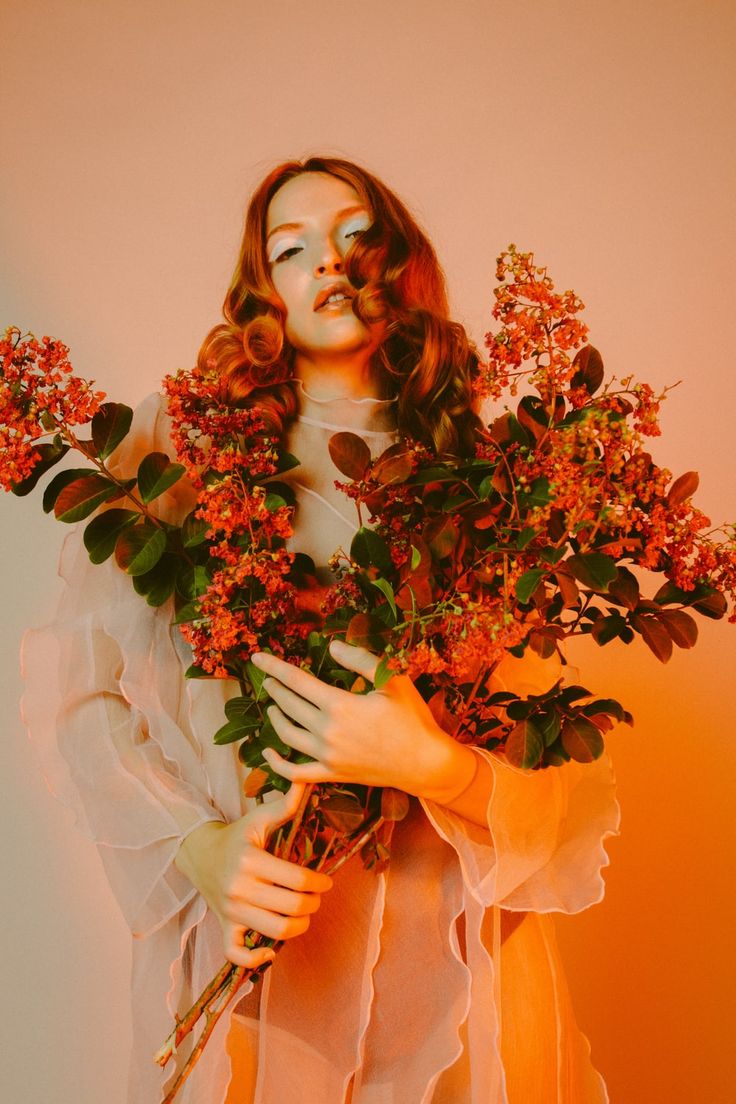 a woman holding flowers in her hands