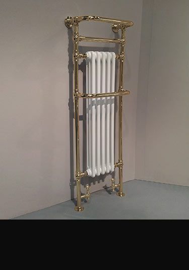 a gold and white radiator in the corner of a room