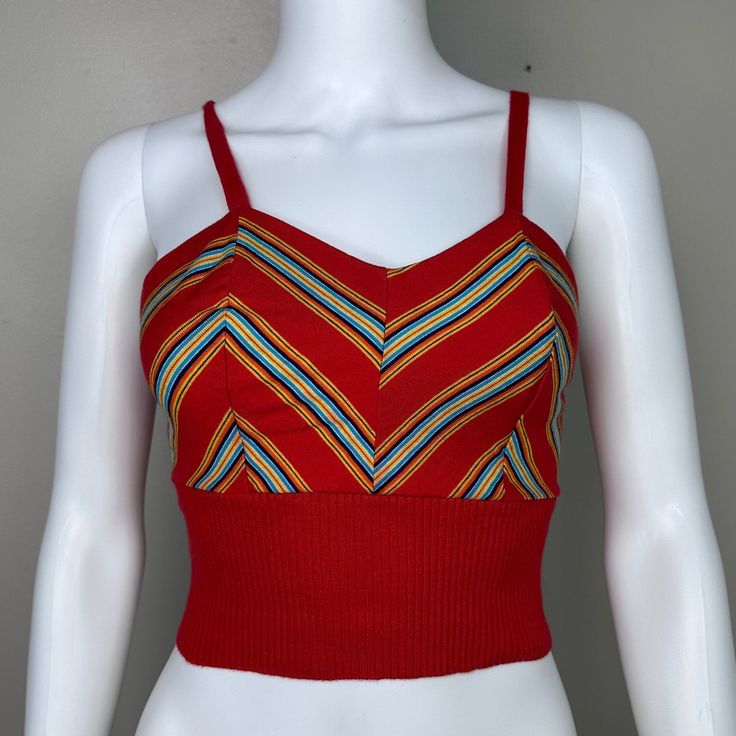 Adorable 70s red knit tank top  Brand - The Red Eye Size - Labeled Medium but it measures like a modern XS so please check all measurements to ensure fit Chest - 15.25" pit to pit, stretches to 17" Waist - 10.75" across, stretches to 15" Length - 15" (11" to underbust) Condition - Someone altered it. The straps originally connected in the back with a button/button hole but someone removed the buttons and stitched down the straps. Multicolor Fitted Retro Tank Top, Red Cotton V-neck Crop Top, Red Fitted Cropped Tank Top, Red Cropped Fitted Tank Top, Retro Red Sleeveless Tank Top, Retro Spring Tank Crop Top, Retro Tank Crop Top For Spring, Vintage Red Sleeveless Top, Retro Fitted Sleeveless Tank Top