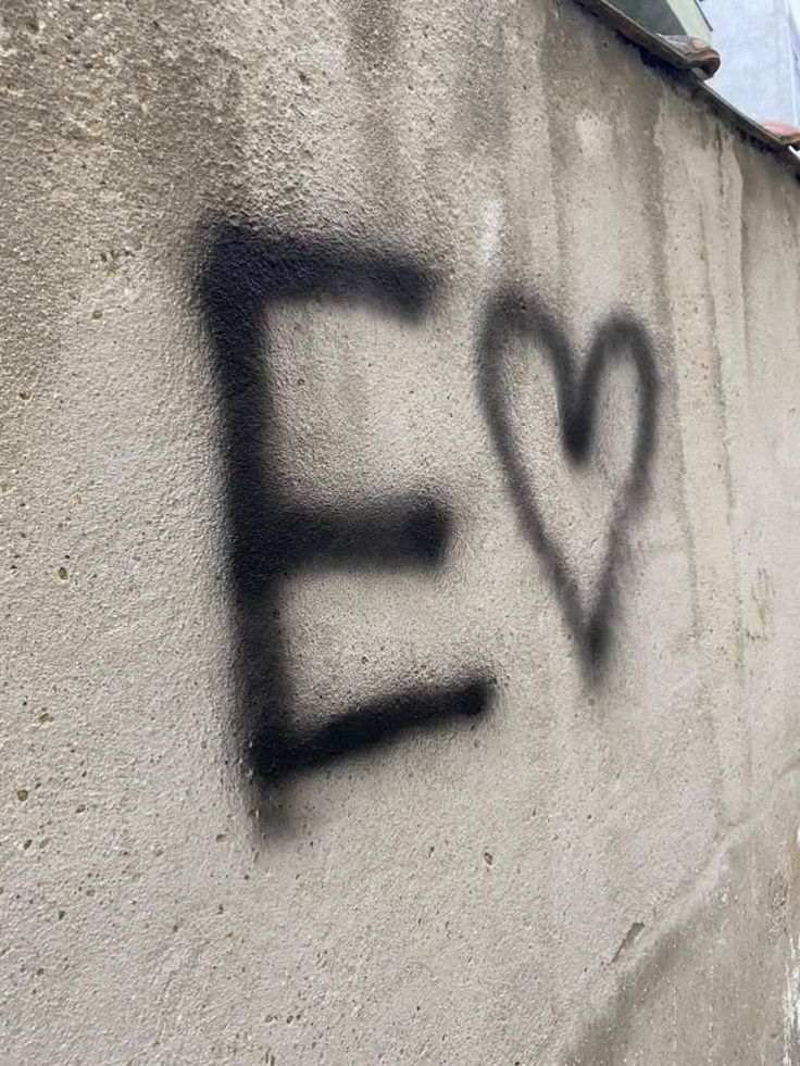 graffiti written on the side of a building that says e is for e with a heart