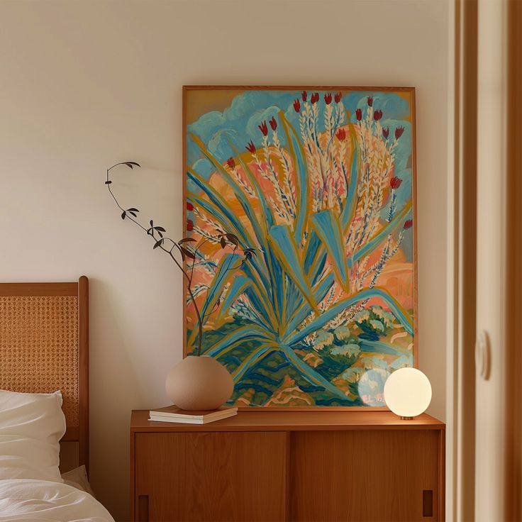 a bedroom with a painting on the wall next to a night stand and nightstands