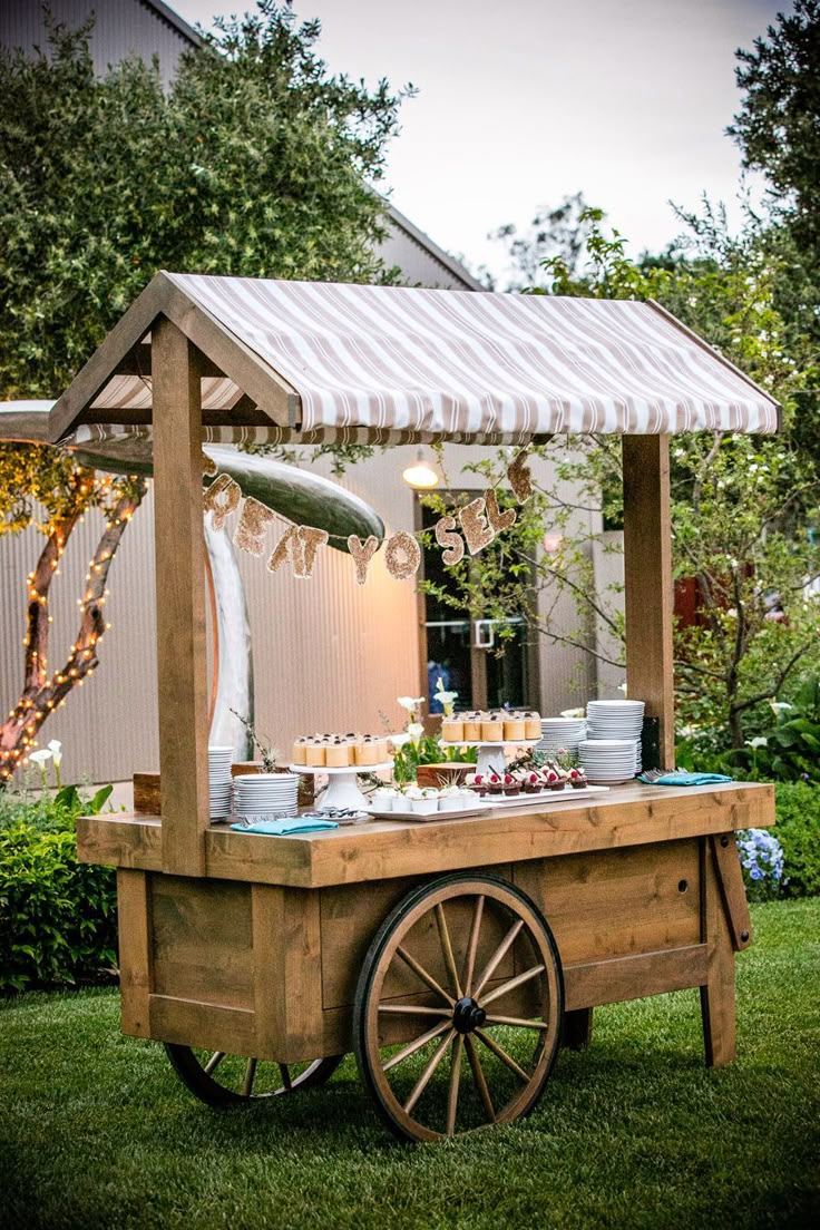 a wooden cart with food on it in the grass