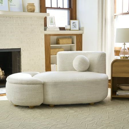 a living room filled with furniture and a fire place in front of a white fireplace