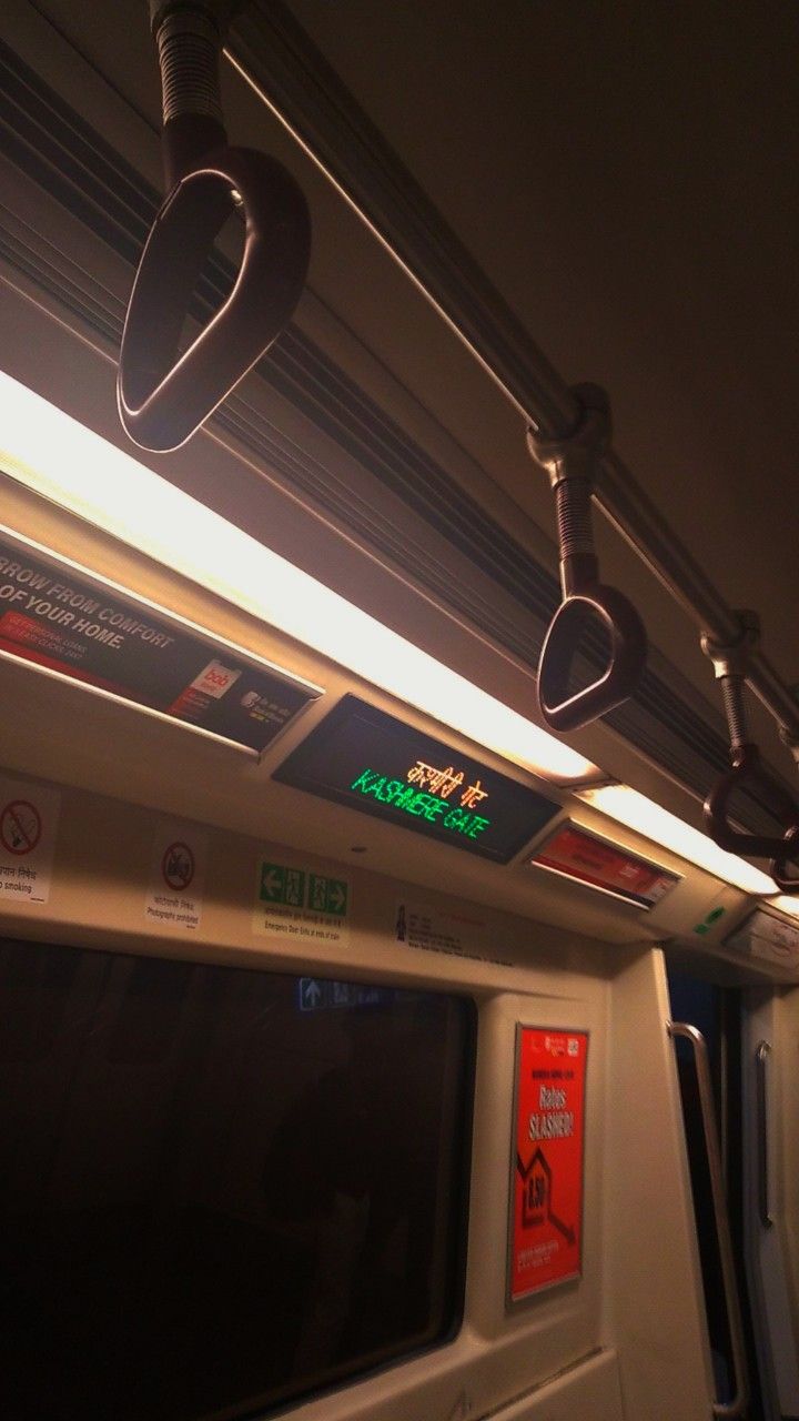 the interior of a subway train with signs and lights