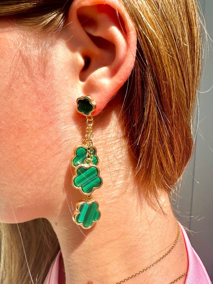 Upgrade your luck with our Luck Galore dangle earrings! These stunning emerald green and gold earrings will add a touch of sparkle to any outfit. Inspired by the iconic Van Cleef & Arpels lucky charm, these earrings are a must-have for any jewelry collection. Boost your luck and style with these elegant earrings. Party Green Gold-plated Earrings, Green Dangling Charms Jewelry, Green Dangle Jewelry With Charms, Green Dangle Jewelry With Dangling Charms, Pierced Green Gold-plated Earrings, Green Gold-plated Pierced Earrings, Green Gold-plated Earrings, Green Pierced Jewelry For Party, Green Jewelry With Dangling Charms As Gift