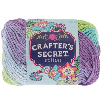 a ball of crafter's secret cotton yarn in pink, grey and white