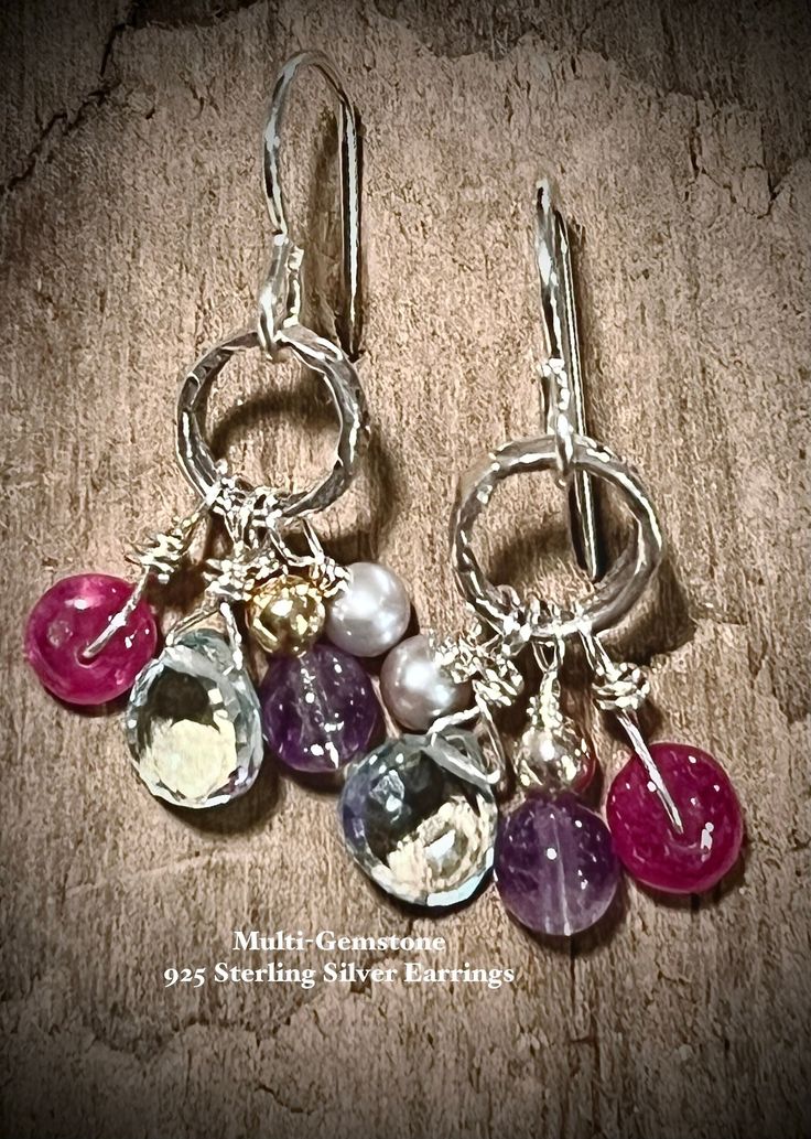 A playful pallet of color in various shapes and size - namely, faceted heart shaped briolette of Aquamarine (6mm), polished round of Amethyst topped by a 14KGF ball, polished rondelle of ruby and Freshwater Pearl- swing from  handcrafted circles of Sterling Silver;  finished on 925SS French ear wires. Approximately 1 1/8" in length - these earrings are petite and pefect for the minimalist who likes a subtle pop of color - enjoy! Sterling Silver Briolette Jewelry For Parties, Sterling Silver Briolette Earrings For Party, Faceted Sterling Silver Gemstones For Jewelry Making, Faceted Dangle Gemstones For Gifts, Silver Multi-stone Briolette Gemstones, Silver Faceted Briolette Gemstones, Silver Briolette Earrings With Birthstone, Faceted Briolette Silver Gemstones, Multicolor Faceted Earrings For Gift