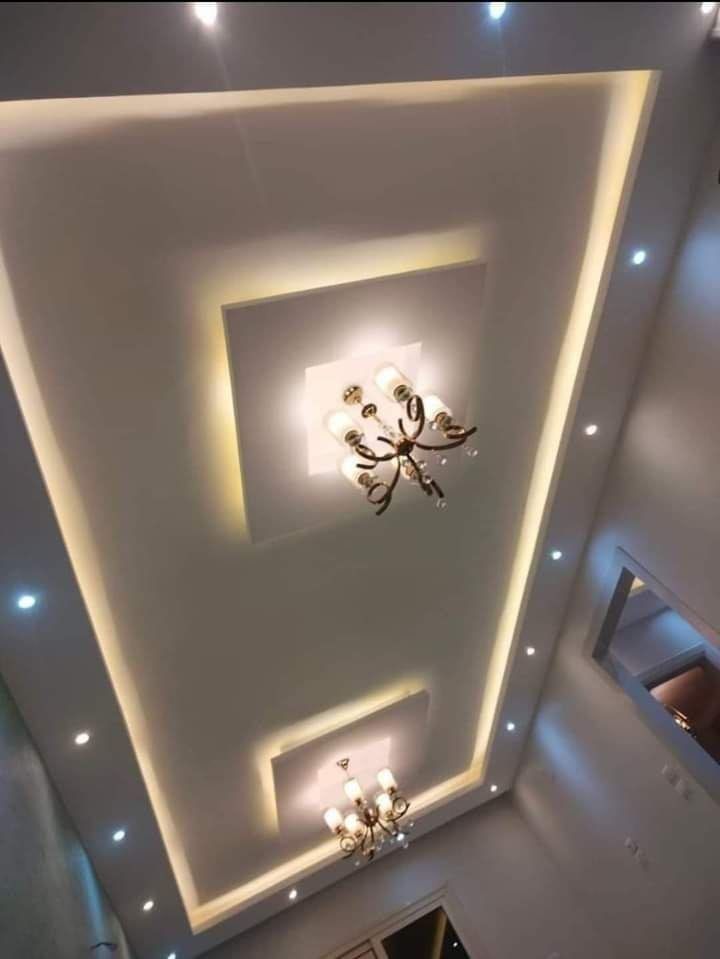 an overhead view of a chandelier in a room with white walls and lights