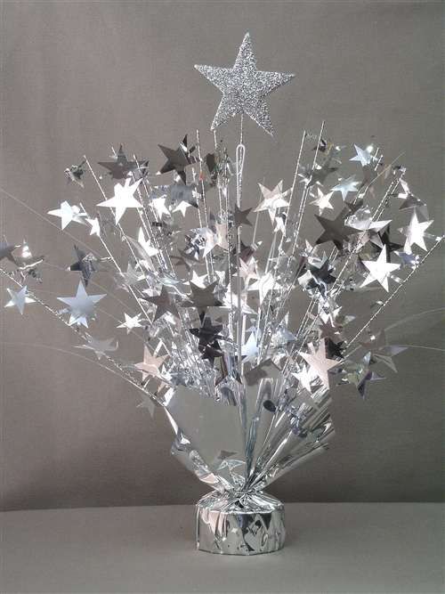 a silver vase filled with stars on top of a table