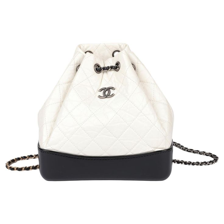 Chanel Black Smooth Calfskin Leather & White Aged Calfskin Leather Gabrielle Backpack Brand- Chanel Model- Gabrielle Backpack Product Type- Backpack Serial Number- 27****** Age- Circa 2018 Accompanied By- Chanel Dust Bag, Authenticity Card Colour- Black, White Hardware- Antiqued Silver, Antiqued Gold, Silver, Champagne Gold Material(s)- Aged Calfskin Leather, Smooth Calfskin Leather Height- 23cm Width- 22.5cm Depth- 10.5cm Strap Drop- 40cm Interior- Burgundy Textile Closure -Drawstring Country of Origin- Italy Condition Rating- Excellent Exterior Condition- The exterior is in excellent condition with minimal signs of use. Interior Condition- The interior is in excellent condition with minimal signs of use. Hardware Condition- The hardware is in excellent condition with minimal signs of use Chanel Backpack Aesthetic, Chanel Gabrielle Backpack, Mochila Chanel, Chanel Luggage, Chanel Gabrielle Bag, Number 27, Chanel Black And White, Aesthetic Backpack, White Hardware