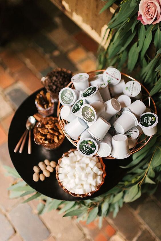 there are many cups and spoons on the table next to each other, including marshmallows