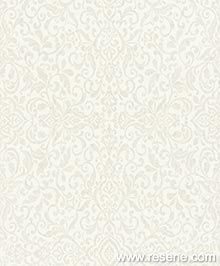 the back side of a white wallpaper with an ornate design on it, and text that