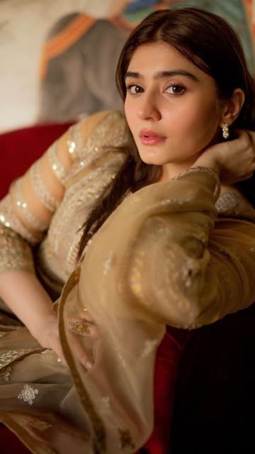 a woman sitting on top of a red couch