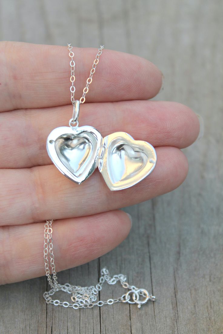 925 sterling silver Puff Heart Locket on a delicate, shimmering silver chain. Insert your own photos or keepsakes. Please select length from the drop down menu. C O M P O N E N T S: Chain - 925 sterling silver (including rings and clasp) Locket - 925 sterling silver, 17.2x18.5mm, double sided with hinge Your item will arrive in a pretty embossed jewelry box - Ready for gift Giving! Elegant Silver Locket Necklace As Gift For Mom, Stamped 925 Heart Pendant Necklace As Gift, Sterling Silver Heart Necklace With Round Pendant For Mom, Silver Heart Necklace For Anniversary, Silver Dainty Heart Necklace For Personalized Gift, Silver Heart Pendant Necklace As Gift For Mom, Heart Pendant Locket Necklace As Mother's Day Gift, Heart Charm Locket Necklace Gift, Sterling Silver Locket Jewelry For Keepsake