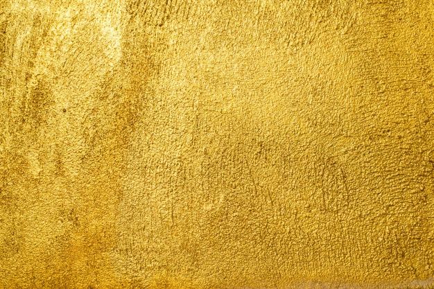 a gold colored wall with some stains on it