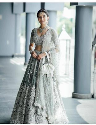 a woman in a white and silver bridal gown