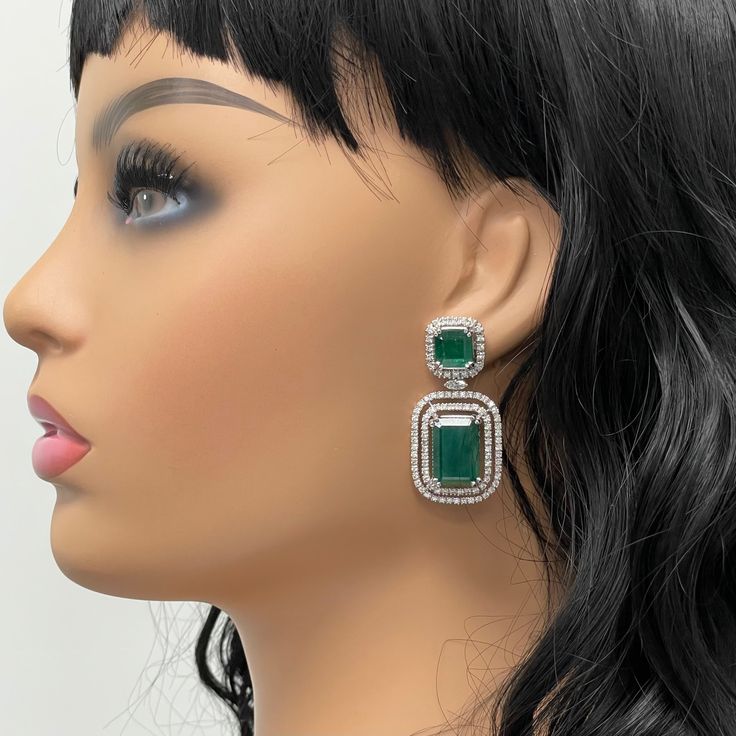 The Renee Emerald & Diamond Earrings are a unique and luxurious heritage pair with royal green emeralds and diamonds set in white gold. Gemstones Type: EmeraldGemstones Shape: RectangularGemstones Weight: 25.01 ctGemstones Color: Green Diamonds Shapes: Round & Marquise Total Diamonds Weight: 3.01 ctDiamonds Color: H - J Diamonds Clarity: VS - SI (Very Slightly Included - Slightly Included) Metal: 14K Gold Metal Wt: 17.4 gms Setting: Prong Set Price Quoted may be negotiable. Please contact us to Green Diamond Earrings With 17 Jewels For Formal Events, Green Diamond Earrings With 17 Jewels For Formal Occasions, Luxury Green Diamond Earrings With Accents, Luxury Green Diamond Earrings For Wedding, Luxury Green Diamond Earrings In Sterling Silver, Green Sterling Silver Luxury Diamond Earrings, Luxury Green Sterling Silver Diamond Earrings, Luxury Green Emerald-cut Earrings, Green Hand Set Diamond Earrings