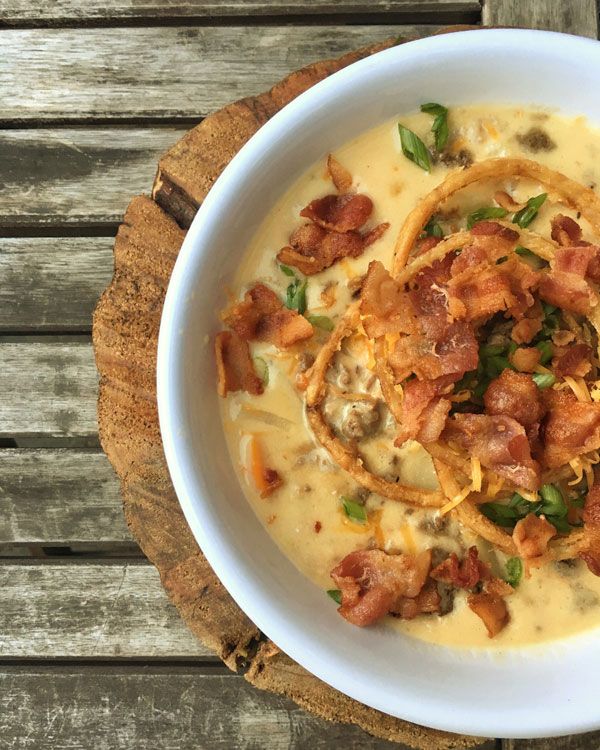 a white bowl filled with soup on top of a wooden table