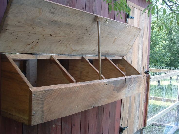 an open wooden box hanging from the side of a building