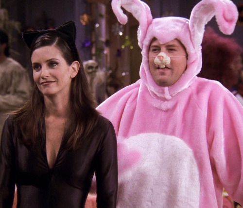 a man and woman in bunny costumes standing next to each other on the set of tv show friends