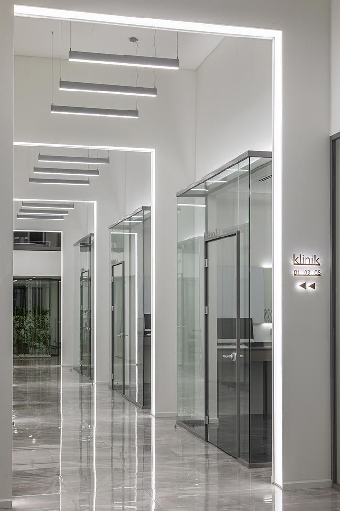 an empty hallway with glass doors and lights