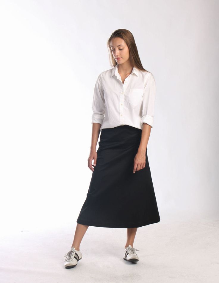 "Be right on clean minimal look with Aline midi skirt in timeless simplicity Black cotton skirt sits a little high on waist making your silhouette long and lean Midi length is super chic for this season Pair with simple top and heels or knee high boots to keep style minimal and polished Or wear as a chic casual skirt paired with snickers or athletic shoes -Tailored fit -Waist sits around naval -Side hidden zipper -Made of soft feel medium weighted cotton fabric with hint of stretch -Finishing is Solid Flowy Skirt For Workwear, Workwear Solid Color Flowy Skirt, Fitted Wrap Skirt For Workwear, Versatile Flowy Skirt For Work, Versatile Fitted Midi Skirt, Office Full Skirt In Solid Color, Versatile Solid Color Midi Skirt, Cotton Pleated Office Skirt, Cotton Pleated Skirt For Office