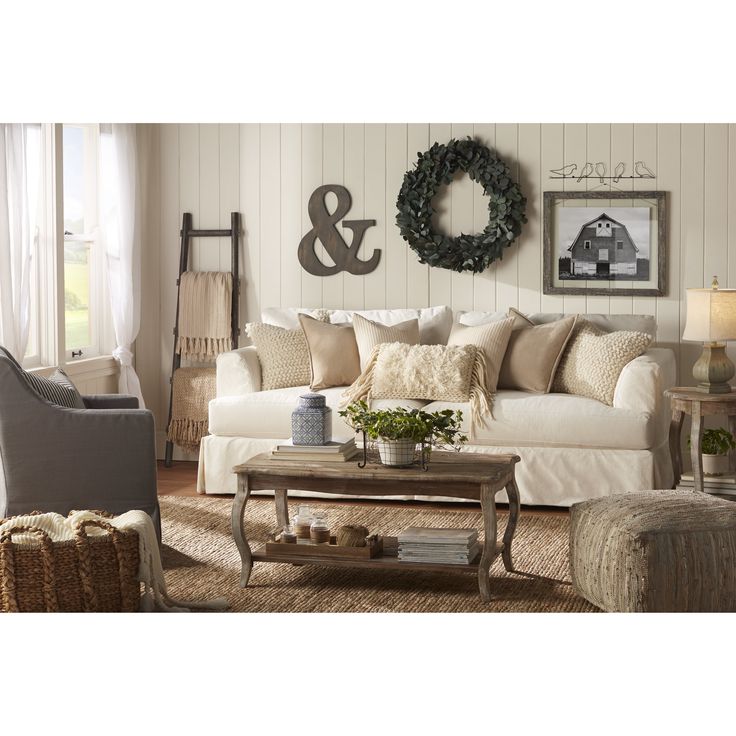 a living room filled with furniture and a wreath hanging on the wall above it's headboard