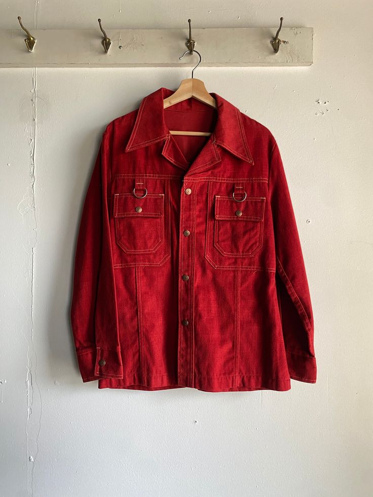 "1970s Red Snap Button Up Jacket made by Gaslight Gamblers. Crimson red in color, made from 100% brushed cotton. Jacket has a front snap button closure with double chest pockets, and gusseted sides. Detailed branded snap buttons. Condition overall is great with no flaws noted. Please see all photos for details. Refer to measurements below to ensure a proper fit 20\" pit to pit 17.5\" shoulder to shoulder 24\" sleeves 28\" in length" Vintage Collared Outerwear With Buttoned Pockets, Vintage Red Button-up Outerwear, Vintage Button-up Outerwear With Snap Buttons, Red Cotton Button-up Outerwear, Vintage Red Single-breasted Outerwear, Vintage Single-breasted Red Outerwear, Retro Button-up Outerwear With Snap Buttons, Retro Snap Button Outerwear, Vintage Red Outerwear With Buttons