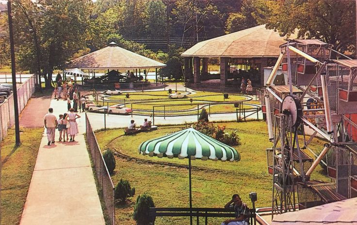 several people are walking around an amusement park