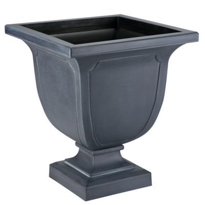 a gray planter sitting on top of a wooden stand