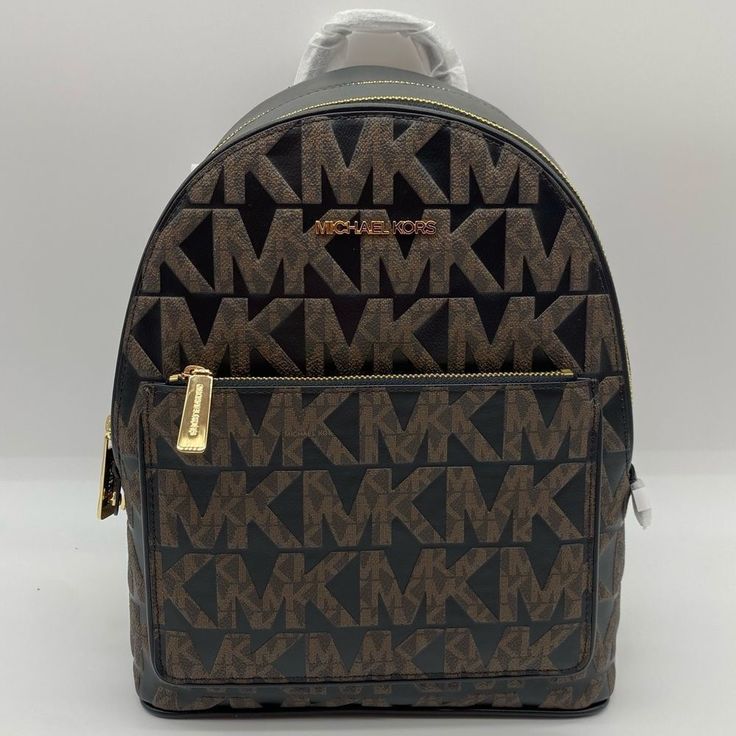 This Michael Kors Adina Zip-Around Backpack In Brown/Black Signature Logo Stamped Coated Canvas And Smooth Leather Is New With Tags In Manufacturer’s Packaging. Features Include: - Adjustable/Convertible Shoulder Straps - Top Handle With 3” Drop - Two Main Zip Compartments & Outer Front Zip Pocket - Inner Zip And Slip Pockets Approximate Measures: 10" W X 12" H X 6" D Reasonable Offers Are Welcome. Designer Brown Standard Backpack, Designer Brown Backpack Bags, Designer Brown Coated Canvas Backpack, Brown Satchel Bag With Logo, Daily Use Brown Coated Canvas Backpack, Brown Coated Canvas Backpack For Daily Use, Brown Coated Canvas Bag With Leather Backing, Brown Coated Canvas Standard Backpack, Designer Brown Backpack